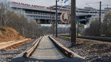 Railway track with the Minsk National Airport terminal in the background